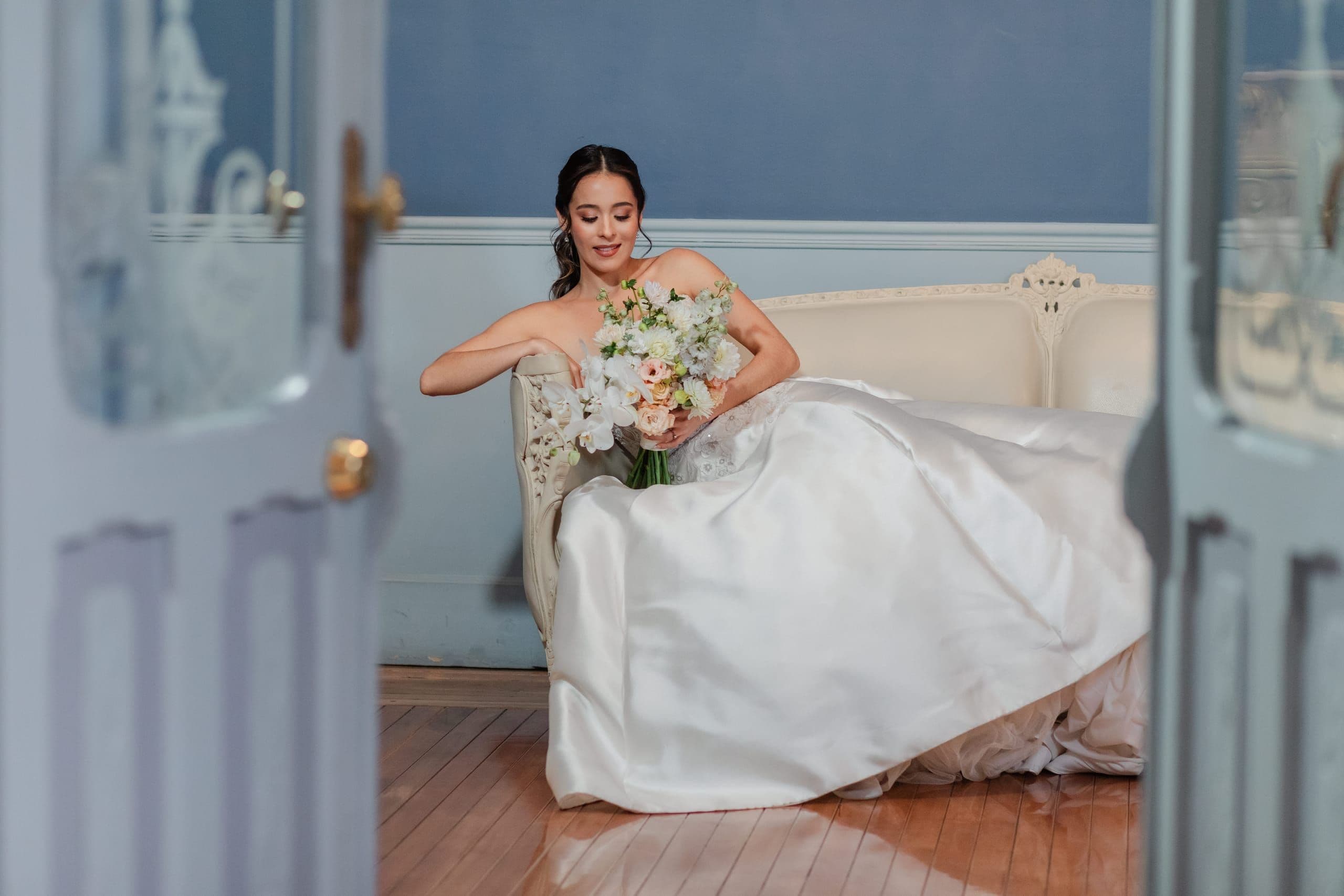 Bride descending the staircase beneath the stained-glass dome of Palacio Julio, a boutique hotel in Puebla's historic center