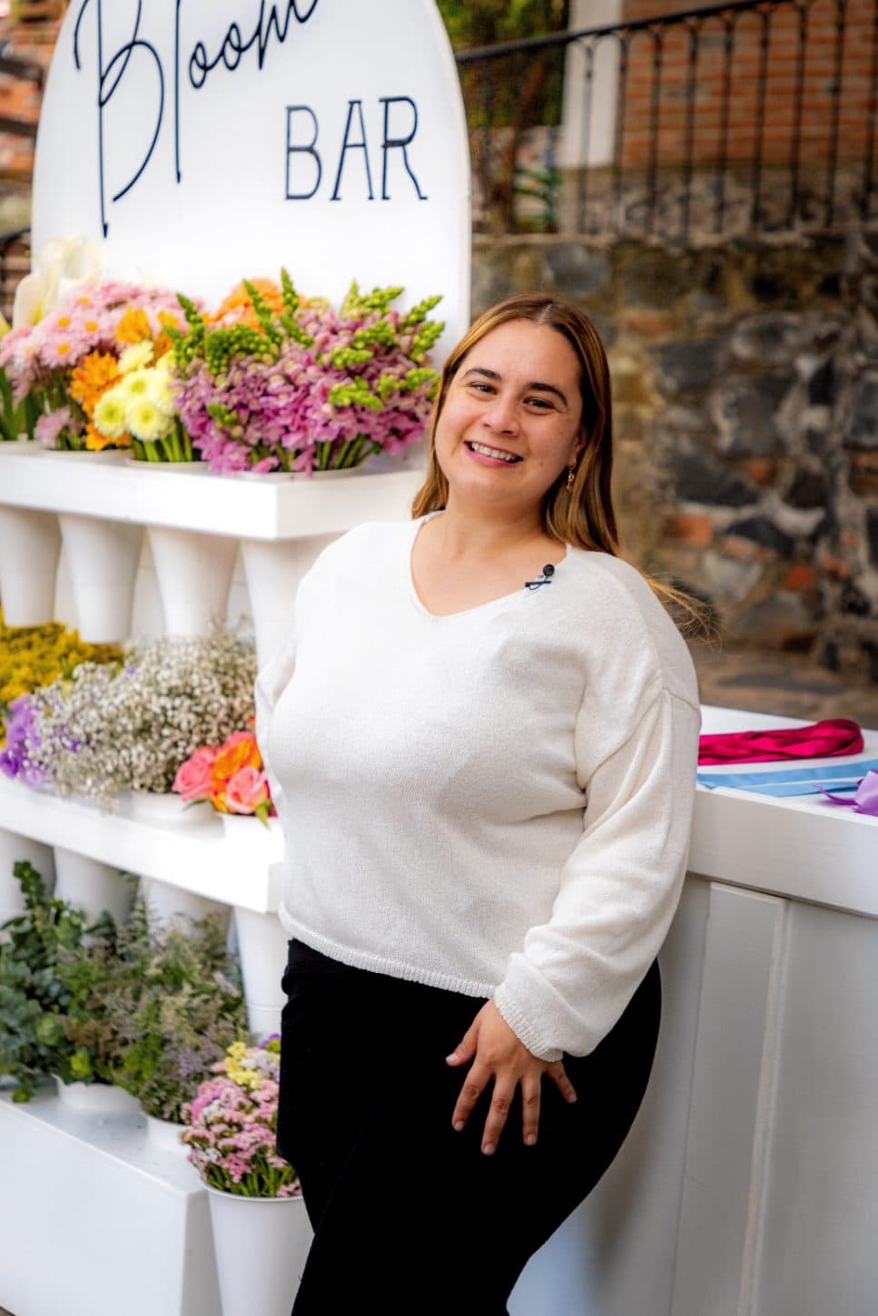 Our florist beside the Bloom Bar stand, ready to welcome guests