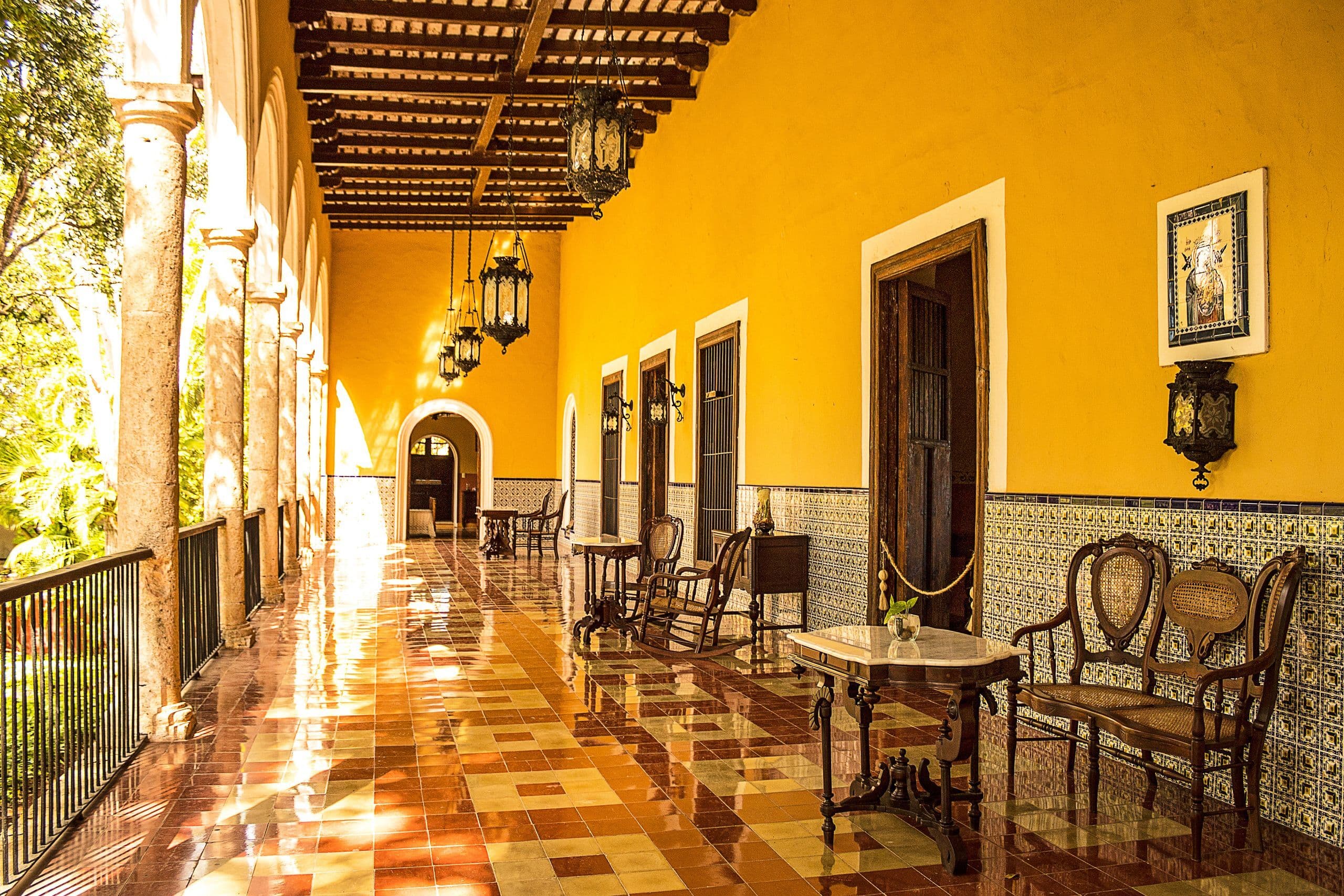 Golden colonial corridor with talavera tiles, wooden beams and antique furniture