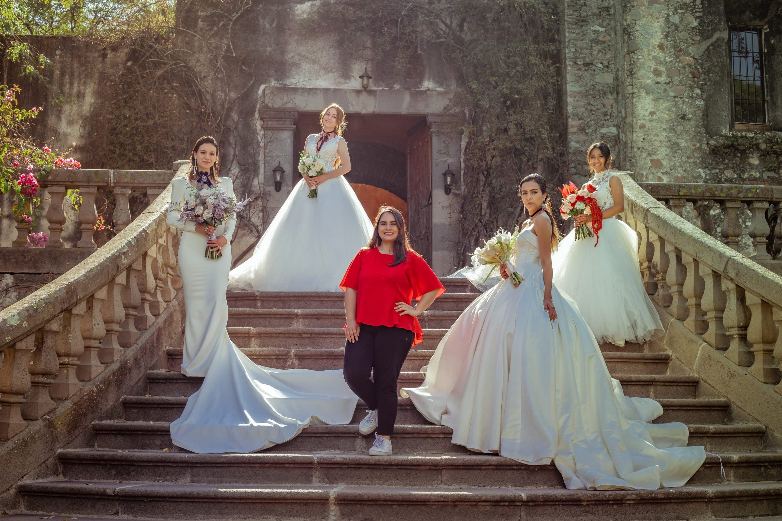Las novias y el equipo en la escalinata de cantera