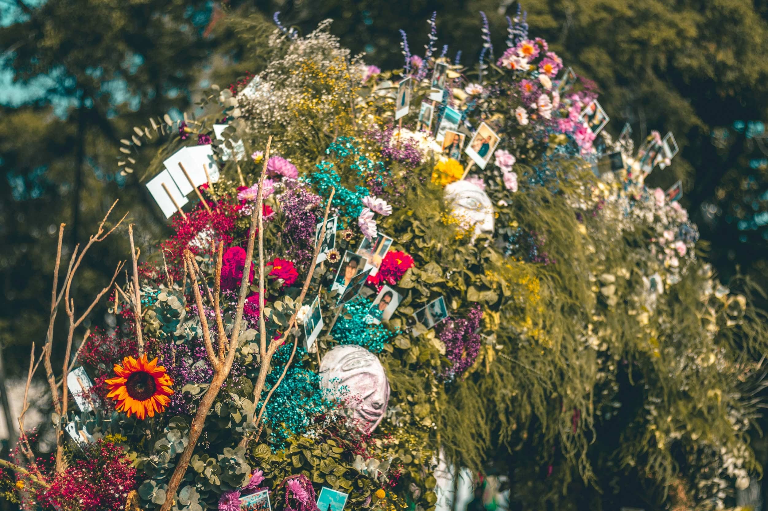 Detalle de flor fresca, girasoles y polaroids de la instalación