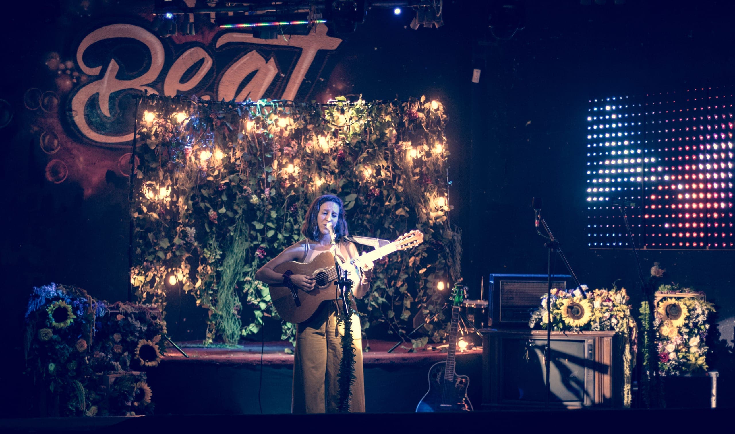 El escenario del concierto de Kevin Kaarl ambientado con un muro floral por Clhei