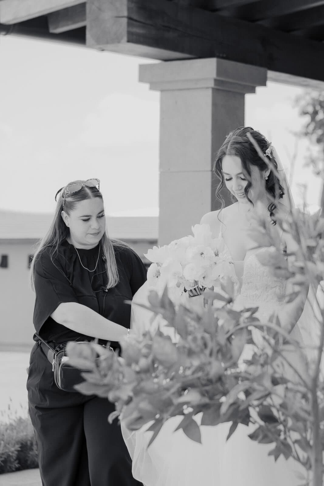 Tania Castorena, founder of Clhei, adjusting a bride's veil before the ceremony